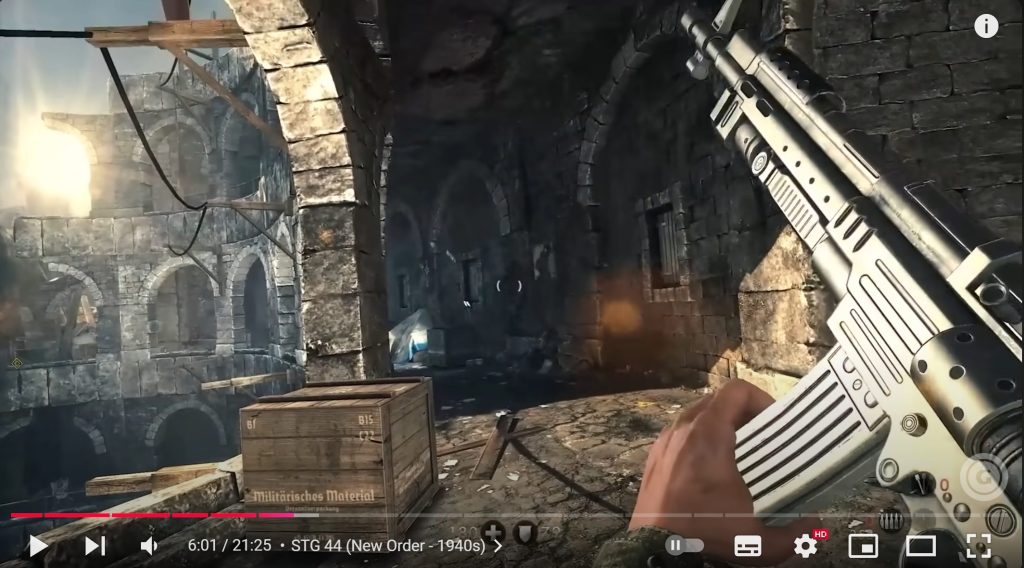 A screenshot from a YouTube video of Wolfenstein: the New Order. The view is of a corridor, open on the left via a series of arches which seem to lead outside. To the right of the frame is a rendition of an assault rifle, held as if at the end of a reloading sequence.